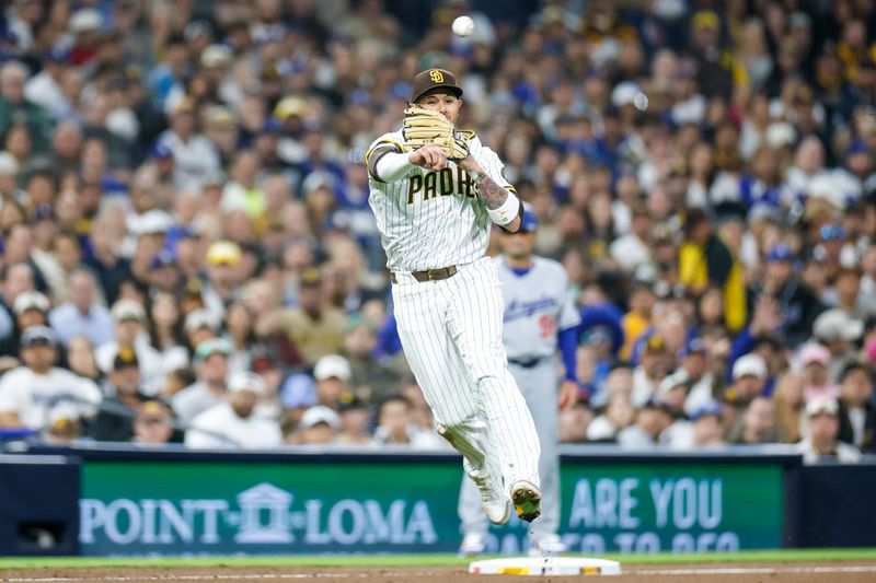 Jun 9, 2025; San Diego, California, USA; San Diego Padres third baseman Manny Machado (13) throws to first for an out during the sixth inning against the Los Angeles Dodgers at Petco Park. Mandatory Credit: David Frerker-Imagn Images