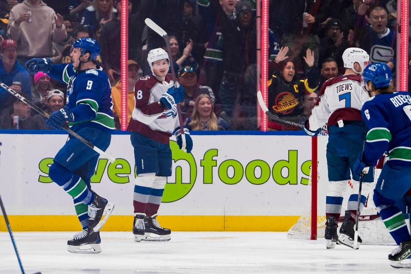 Mar 13, 2024; Vancouver, British Columbia, CAN; Colorado Avalanche defenseman Cale Makar (8) watches as Vancouver Canucks forward J.T. Miller (9) celebrates his goal  in the first period at Rogers Arena. Mandatory Credit: Bob Frid-USA TODAY Sports