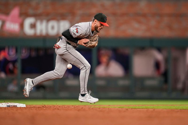 Apr 5, 2024; Cumberland, Georgia, USA; Arizona Diamondbacks shortstop Blaze Alexander (9) commits an error on a ball hit by Atlanta Braves third base Austin Riley (27) (not shown) during the ninth inning at Truist Park. Mandatory Credit: Dale Zanine-USA TODAY Sports