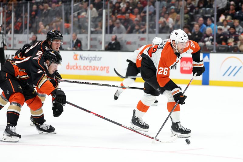 Nov 10, 2023; Anaheim, California, USA; Philadelphia Flyers defenseman Sean Walker (26) shoots the puck past Anaheim Ducks right wing Frank Vatrano (77) during the first period at Honda Center. Mandatory Credit: Kiyoshi Mio-USA TODAY Sports