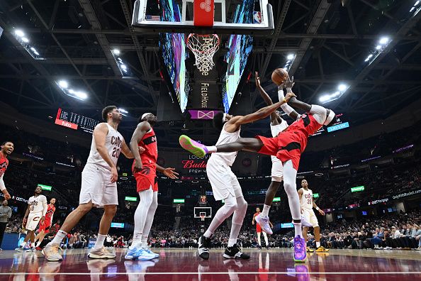 CLEVELAND, OHIO - NOVEMBER 26: Chris Boucher #25 of the Toronto Raptors is fouled by Jarrett Allen #31 of the Cleveland Cavaliers during the first half at Rocket Mortgage Fieldhouse on November 26, 2023 in Cleveland, Ohio. The Cavaliers defeated the Raptors 105-102. NOTE TO USER: User expressly acknowledges and agrees that, by downloading and or using this photograph, User is consenting to the terms and conditions of the Getty Images License Agreement. (Photo by Jason Miller/Getty Images)