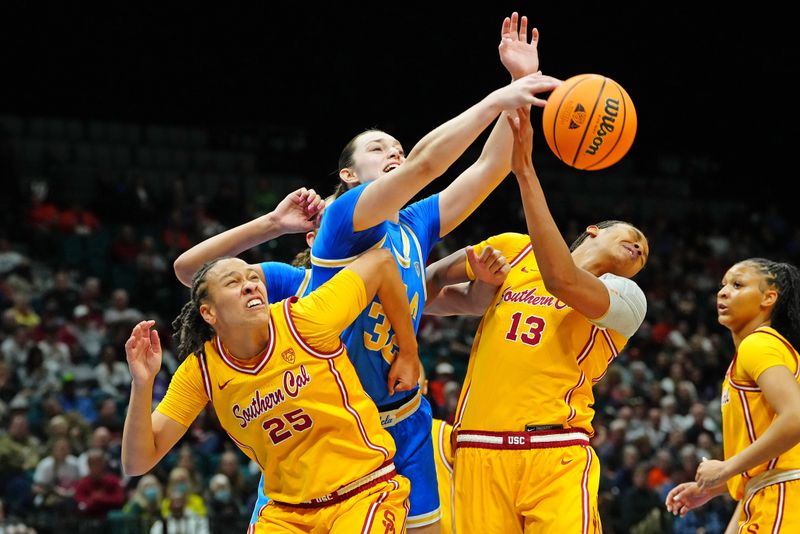 Mar 8, 2024; Las Vegas, NV, USA; UCLA Bruins forward Angela Dugalic (32) reaches for a rebound while being blocked out by USC Trojans guard McKenzie Forbes (25) and USC Trojans center Rayah Marshall (13) during the second quarter at MGM Grand Garden Arena. Mandatory Credit: Stephen R. Sylvanie-USA TODAY Sports