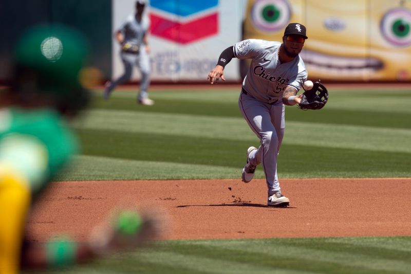 Aug 7, 2024; Oakland, California, USA; Chicago White Sox third baseman Lenyn Sosa (50) fields a ground ball by Oakland Athletics left fielder Miguel Andujar during the first inning at Oakland-Alameda County Coliseum. Mandatory Credit: D. Ross Cameron-USA TODAY Sports