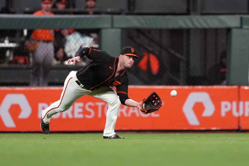 Jun 3, 2023; San Francisco, California, USA;  San Francisco Giants center fielder Austin Slater (13) catches a fly ball against the Baltimore Orioles during the seventh inning at Oracle Park. Mandatory Credit: Darren Yamashita-USA TODAY Sports