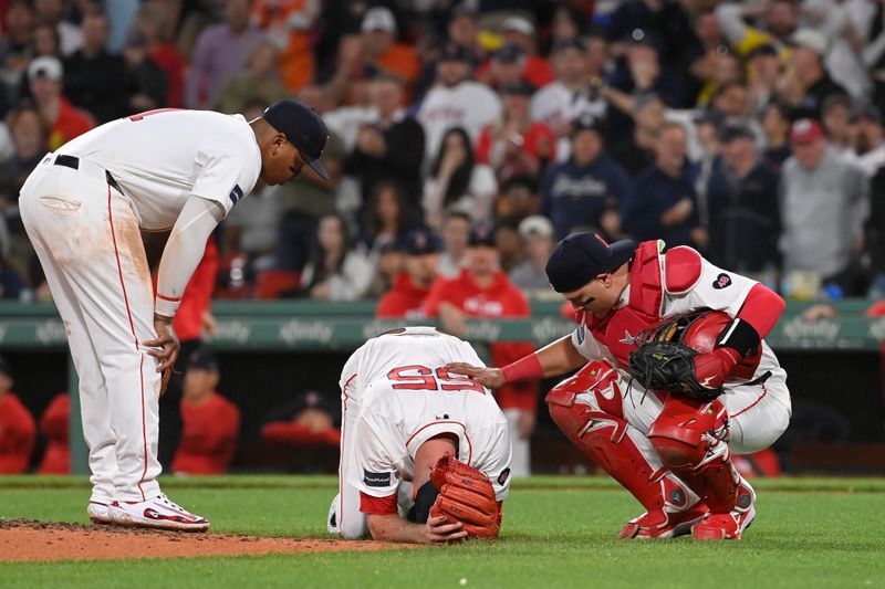 May 14, 2024; Boston, Massachusetts, USA; Boston Red Sox third baseman Rafael Devers (11) (L) and catcher Reese McGuire (3) (R) check on pitcher Chris Martin (55) during the eighth inning against the Tampa Bay Rays at Fenway Park. Mandatory Credit: Eric Canha-USA TODAY Sports