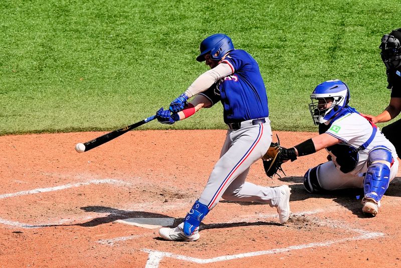 Jul 28, 2024; Toronto, Ontario, CAN; Texas Rangers left fielder Robbie Grossman (4) hits a single against the Toronto Blue Jays  during the eighth inning at Rogers Centre. Mandatory Credit: John E. Sokolowski-USA TODAY Sports