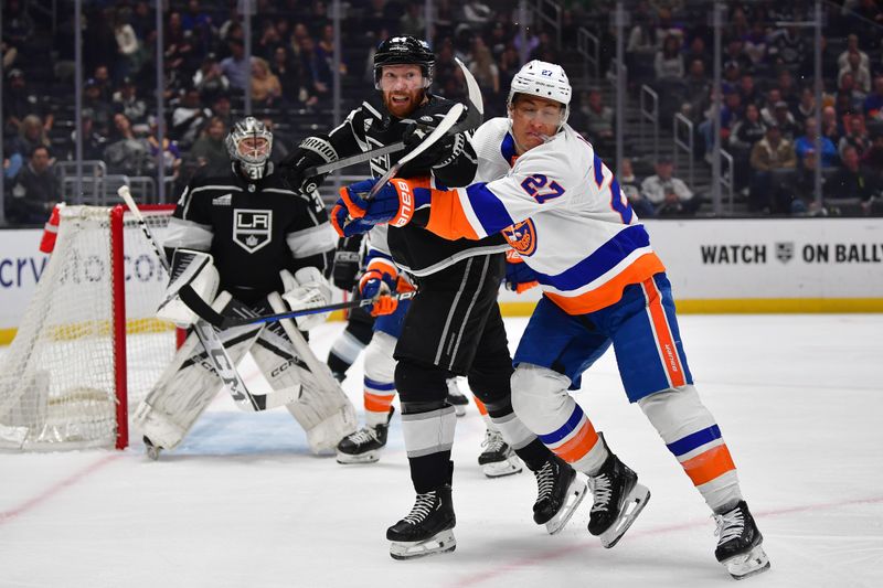 Mar 11, 2024; Los Angeles, California, USA; Los Angeles Kings defenseman Vladislav Gavrikov (84) plays for the puck against New York Islanders left wing Anders Lee (27) during the first period at Crypto.com Arena. Mandatory Credit: Gary A. Vasquez-USA TODAY Sports