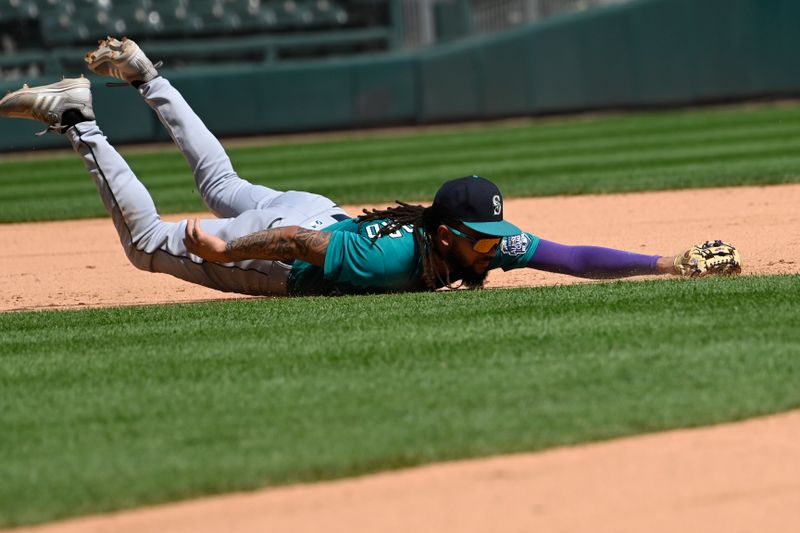 Aug 23, 2023; Chicago, Illinois, USA;  Seattle Mariners shortstop J.P. Crawford (3) tries to make the play on the RBI single hit by Chicago White Sox shortstop Tim Anderson (7) during the third inning at Guaranteed Rate Field. Mandatory Credit: Matt Marton-USA TODAY Sports