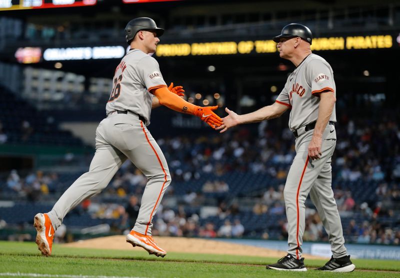 May 21, 2024; Pittsburgh, Pennsylvania, USA;  San Francisco Giants third base coach Matt Williams (right) congratulates third baseman Matt Chapman (26) as he circles the bases on a solo home run against the Pittsburgh Pirates during the seventh inning at PNC Park. Mandatory Credit: Charles LeClaire-USA TODAY Sports