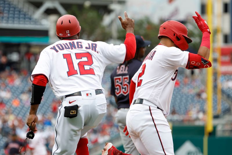 Apr 16, 2023; Washington, District of Columbia, USA; Washington Nationals second baseman Luis Garcia (2) celebrates with Nationals first base coach Eric Young Jr. (12) while rounding the bases after hitting a two run home run against the Cleveland Guardians during the seventh inning  at Nationals Park. Mandatory Credit: Geoff Burke-USA TODAY Sports