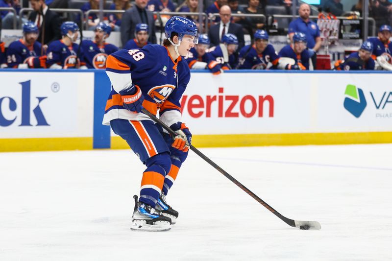 Dec 27, 2025; Elmont, New York, USA;  New York Islanders defenseman Matthew Schaefer (48) controls the puck in the first period against the New York Rangers at UBS Arena. Mandatory Credit: Wendell Cruz-Imagn Images