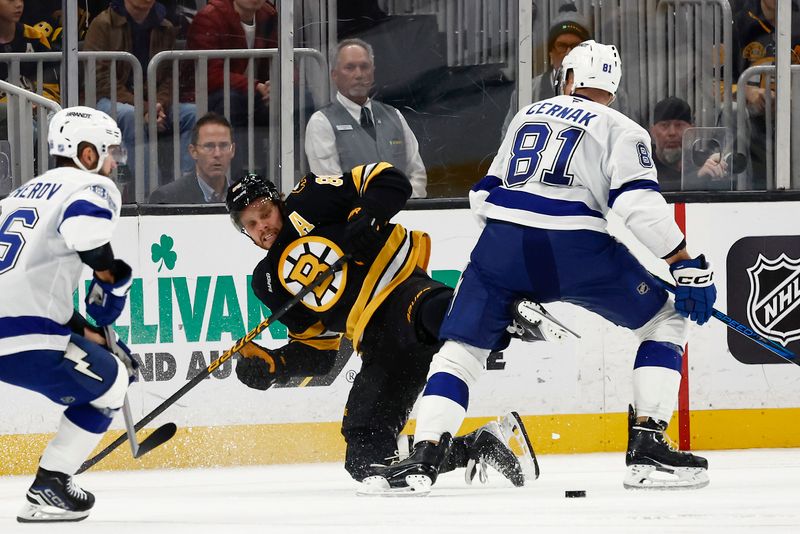 Oct 13, 2025; Boston, Massachusetts, USA; Boston Bruins right wing David Pastrnak (88) is checked off the puck by Tampa Bay Lightning defenseman Erik Cernak (81) during the third period at TD Garden. Mandatory Credit: Winslow Townson-Imagn Images
