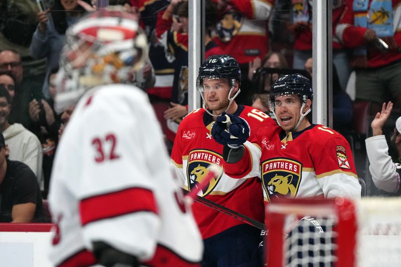 Nov 10, 2023; Sunrise, Florida, USA; Florida Panthers center Aleksander Barkov (16) celebrates his goal against the Carolina Hurricanes with center Evan Rodrigues (17) during the second period at Amerant Bank Arena. Mandatory Credit: Jasen Vinlove-USA TODAY Sports