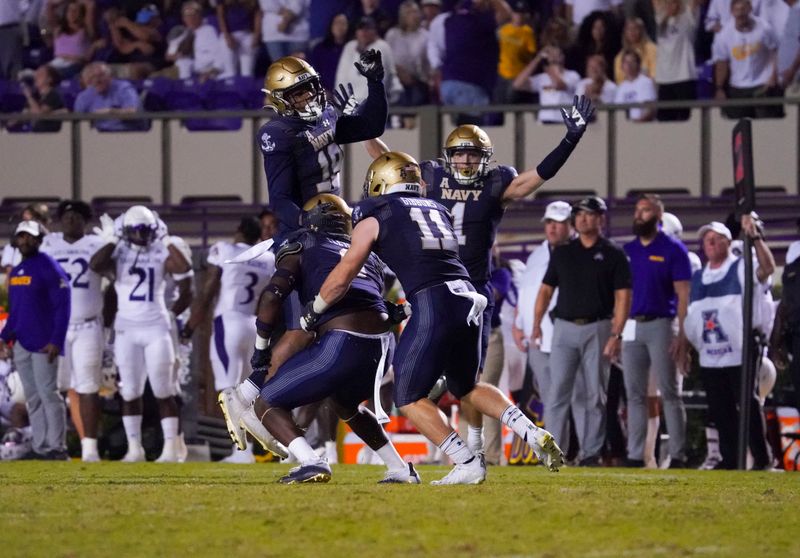 Sep 24, 2022; Greenville, North Carolina, USA;  Navy Midshipmen linebacker Tyler Fletcher (0) is congratulated  by linebacker Eavan Gibbons (11) safety Rayuan Lane III (18) and linebacker John Marshall (1) intercepts a pass against the East Carolina Pirates in the overtime at Dowdy-Ficklen Stadium. Mandatory Credit: James Guillory-USA TODAY Sports