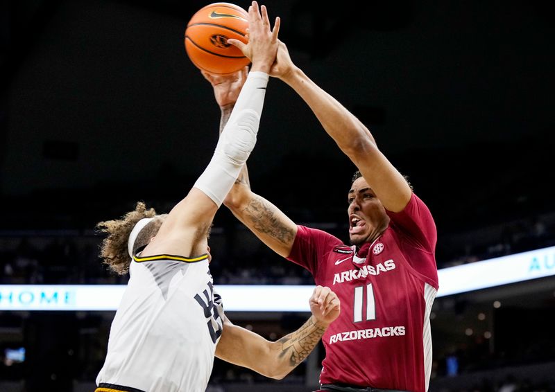 Jan 31, 2024; Columbia, Missouri, USA; Arkansas Razorbacks forward Jalen Graham (11) passes the ball Missouri Tigers forward Noah Carter (35) during the second half at Mizzou Arena. Mandatory Credit: Jay Biggerstaff-USA TODAY Sports