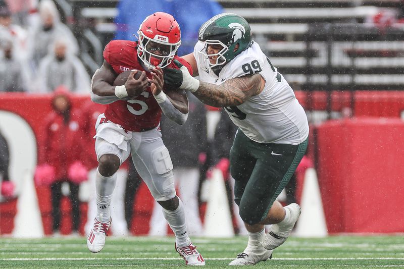 Oct 14, 2023; Piscataway, New Jersey, USA; Rutgers Scarlet Knights running back Kyle Monangai (5) fights for yards against Michigan State Spartans defensive lineman Jalen Sami (99) during the second half at SHI Stadium. Mandatory Credit: Vincent Carchietta-USA TODAY Sports