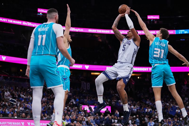 ORLANDO, FLORIDA - FEBRUARY 12: Paolo Banchero #5 of the Orlando Magic goes up for a shot against Tidjane Salaun #31 of the Charlotte Hornets during the third quarter at Kia Center on February 12, 2025 in Orlando, Florida. NOTE TO USER: User expressly acknowledges and agrees that, by downloading and or using this photograph, user is consenting to the terms and conditions of the Getty Images License Agreement. (Photo by Rich Storry/Getty Images)