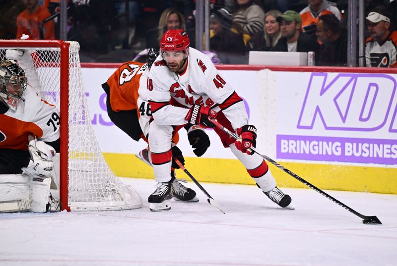 Nov 28, 2023; Philadelphia, Pennsylvania, USA; Carolina Hurricanes left wing Jordan Martinook (48) controls the puck against Philadelphia Flyers center Morgan Frost (48) in the third period at Wells Fargo Center. Mandatory Credit: Kyle Ross-USA TODAY Sports