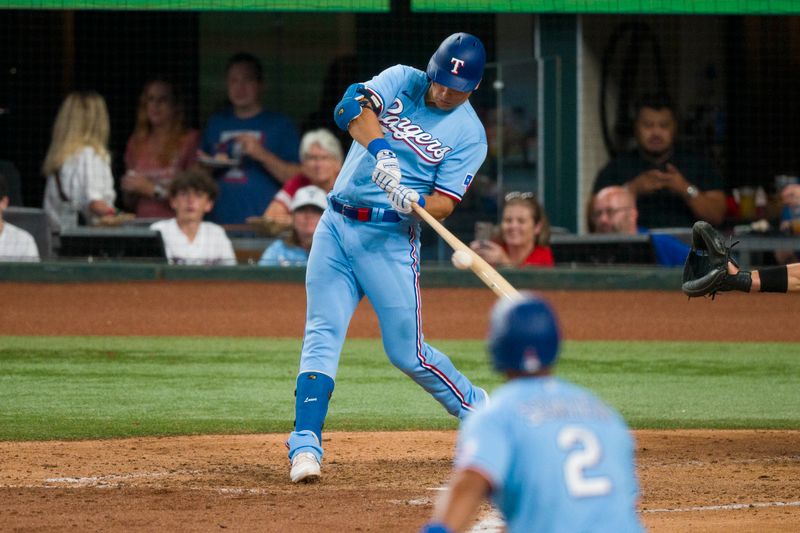 Sep 10, 2023; Arlington, Texas, USA; Texas Rangers first baseman Nathaniel Lowe (30) hits a double and drives in two runs against the Oakland Athletics during the fifth inning at Globe Life Field. Mandatory Credit: Jerome Miron-USA TODAY Sports
