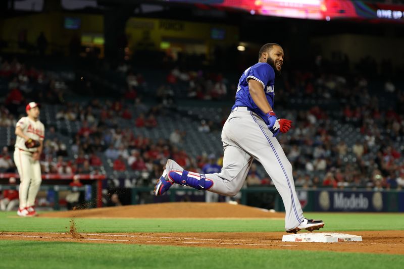 May 7, 2025; Anaheim, California, USA;  Toronto Blue Jays first baseman Vladimir Guerrero Jr. (27) hits a double during the sixth inning against the Los Angeles Angels at Angel Stadium. Mandatory Credit: Kiyoshi Mio-Imagn Images