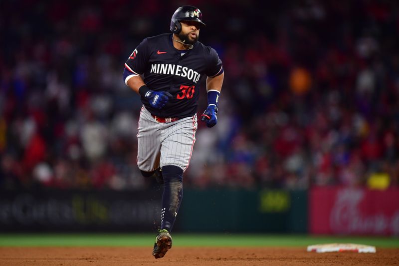 Apr 27, 2024; Anaheim, California, USA;  Minnesota Twins first baseman Carlos Santana (30) rounds the bases after hitting a three run home run against the Los Angeles Angels during the fourth inning at Angel Stadium. Mandatory Credit: Gary A. Vasquez-USA TODAY Sports