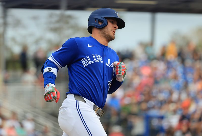 Mar 14, 2026; Dunedin, Florida, USA;  Toronto Blue Jays center fielder Daulton Varsho (5) hits a home run during the fifth inning against the Detroit Tigers at TD Ballpark. Mandatory Credit: Kim Klement Neitzel-Imagn Images
