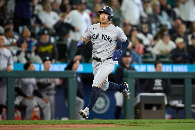 May 14, 2025; Seattle, Washington, USA; New York Yankees shortstop Anthony Volpe (11) runs home to score during the sixth inning against the Seattle Mariners at T-Mobile Park. Mandatory Credit: John Froschauer-Imagn Images