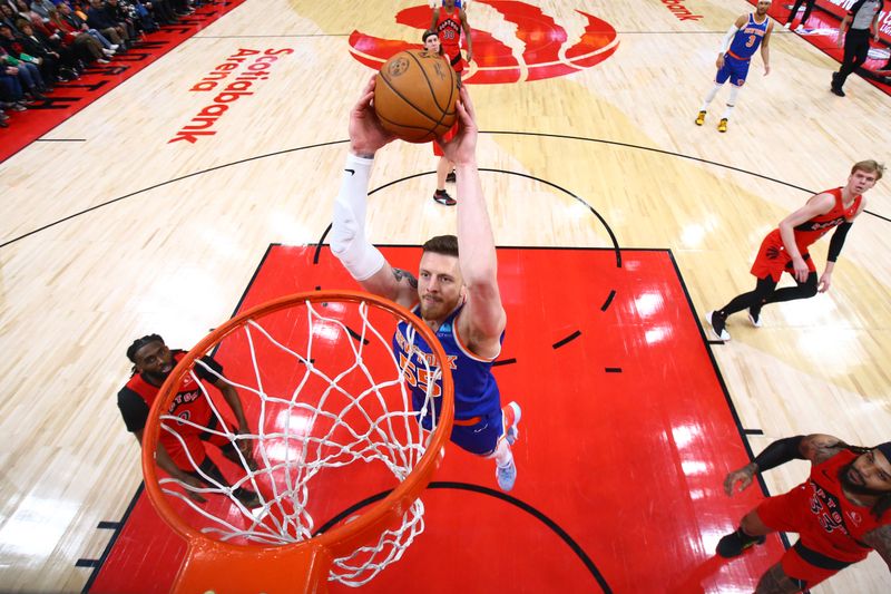 TORONTO, CANADA - MARCH 27: Isaiah Hartenstein #55 of the New York Knicks dunks the ball during the game against the Toronto Raptors on March 27, 2024 at the Scotiabank Arena in Toronto, Ontario, Canada.  NOTE TO USER: User expressly acknowledges and agrees that, by downloading and or using this Photograph, user is consenting to the terms and conditions of the Getty Images License Agreement.  Mandatory Copyright Notice: Copyright 2024 NBAE (Photo by Vaughn Ridley/NBAE via Getty Images)