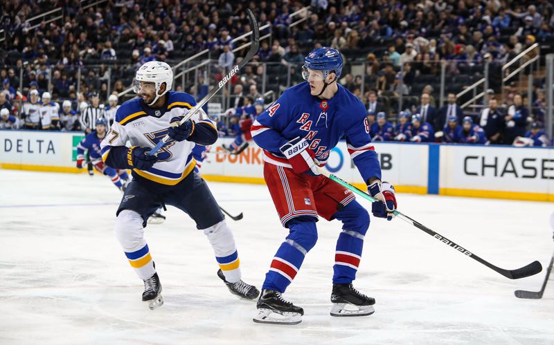 Nov 25, 2024; New York, New York, USA; New York Rangers center Adam Edstrom (84) and St. Louis Blues defenseman Pierre-Olivier Joseph (77) tangle in front of the net during the second period at Madison Square Garden. Mandatory Credit: Danny Wild-Imagn Images