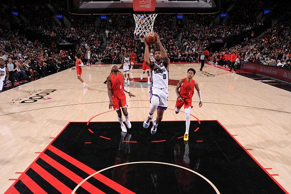 PORTLAND, OR - DECEMBER 26: Malik Monk #0 of the Sacramento Kings drives to the basket during the game against the Portland Trail Blazers on December 26, 2023 at the Moda Center Arena in Portland, Oregon. NOTE TO USER: User expressly acknowledges and agrees that, by downloading and or using this photograph, user is consenting to the terms and conditions of the Getty Images License Agreement. Mandatory Copyright Notice: Copyright 2023 NBAE (Photo by Cameron Browne/NBAE via Getty Images)