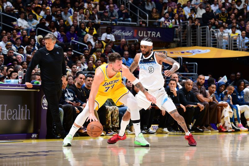 LOS ANGELES, CA - FEBRUARY 27: Luka Doncic #77 of the Los Angeles Lakers handles the ball while Nickeil Alexander-Walker #9 of the Minnesota Timberwolves plays defense during the game on February 27, 2025 at Crypto.Com Arena in Los Angeles, California. NOTE TO USER: User expressly acknowledges and agrees that, by downloading and/or using this Photograph, user is consenting to the terms and conditions of the Getty Images License Agreement. Mandatory Copyright Notice: Copyright 2025 NBAE (Photo by Adam Pantozzi/NBAE via Getty Images)