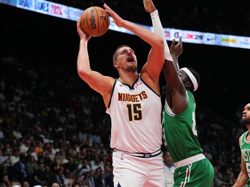 ABU DHABI, UAE - OCTOBER 6: Nikola Jokic #15 of the Denver Nuggets drives to the basket during the game against the Boston Celtics during the 2024 Global Games on October 6, 2024 at the Etihad Arena in Abu Dhabi, United Arab Emirates. NOTE TO USER: User expressly acknowledges and agrees that, by downloading and/or using this Photograph, user is consenting to the terms and conditions of the Getty Images License Agreement. Mandatory Copyright Notice: Copyright 2024 NBAE (Photo by Garrett Ellwood/NBAE via Getty Images)