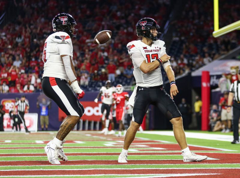 Sep 4, 2021; Houston, Texas, USA; Texas Tech Red Raiders quarterback Tyler Shough (12) reacts after rushing for a touchdown during the third quarter against the Houston Cougars at NRG Stadium. Mandatory Credit: Troy Taormina-USA TODAY Sports