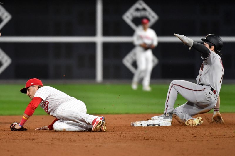 Oct 24, 2023; Philadelphia, Pennsylvania, USA; Arizona Diamondbacks left fielder Corbin Carroll (7) steals second base against Philadelphia Phillies second baseman Bryson Stott (5) in the fifth inning during game seven of the NLCS for the 2023 MLB playoffs at Citizens Bank Park. Mandatory Credit: Eric Hartline-USA TODAY Sports