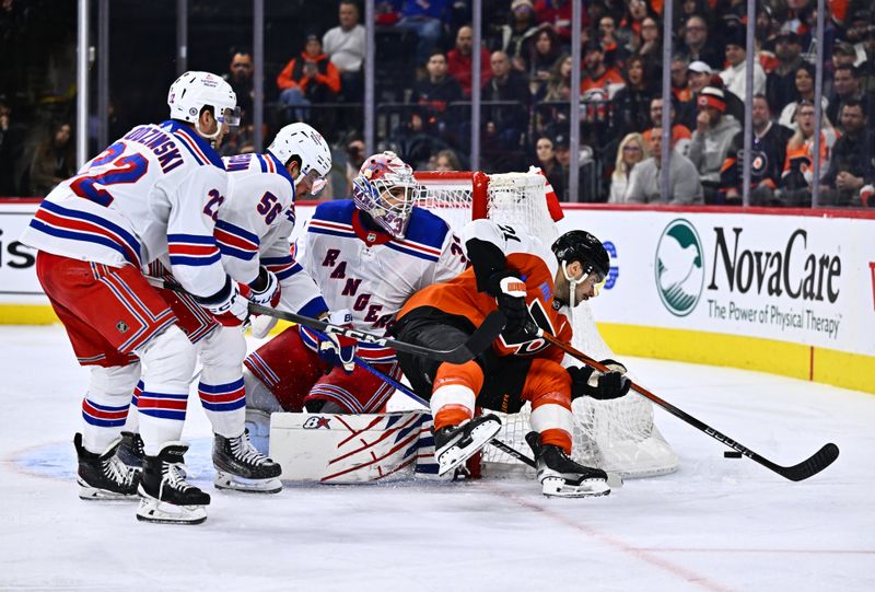 Feb 24, 2024; Philadelphia, Pennsylvania, USA; Philadelphia Flyers center Scott Laughton (21) dives for a loose puck against New York Rangers goalie Igor Shesterkin (31) in the third period at Wells Fargo Center. Mandatory Credit: Kyle Ross-USA TODAY Sports