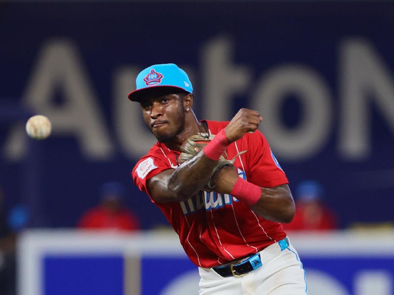 Apr 27, 2024; Miami, Florida, USA; Miami Marlins shortstop Tim Anderson (7) throws to first base against the Washington Nationals during the fourth inning at loanDepot Park. Mandatory Credit: Sam Navarro-USA TODAY Sports