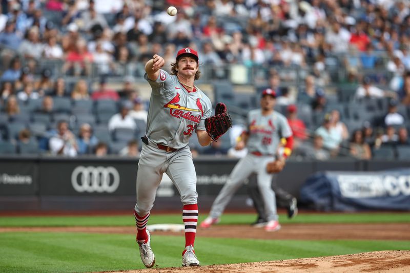 Sep 1, 2024; Bronx, New York, USA;  St. Louis Cardinals starting pitcher Miles Mikolas (39) attempts to throw out a runner at first base in the fifth inning against the New York Yankees at Yankee Stadium. Mandatory Credit: Wendell Cruz-USA TODAY Sports