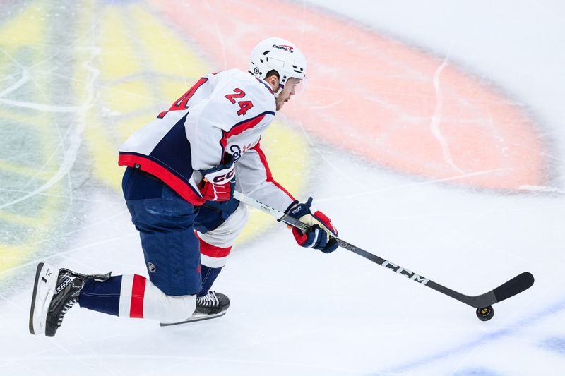 Dec 10, 2023; Chicago, Illinois, USA; Washington Capitals center Connor McMichael (24) skates with the puck against the Chicago Blackhawks during the third period at the United Center. Mandatory Credit: Daniel Bartel-USA TODAY Sports