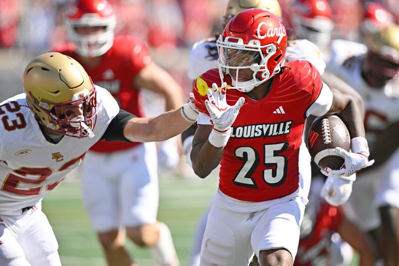 Sep 23, 2023; Louisville, Kentucky, USA;   Louisville Cardinals running back Jawhar Jordan (25) avoids the tackle of Boston College Eagles defensive back Cole Batson (23) to run in a touchdown during the first quarter at L&N Federal Credit Union Stadium. Mandatory Credit: Jamie Rhodes-USA TODAY Sports