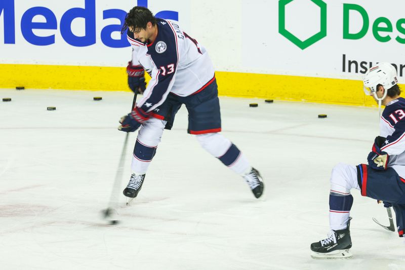 Dec 3, 2024; Calgary, Alberta, CAN; Columbus Blue Jackets center Sean Monahan (23) controls the puck wearing late Johnny Gaudreau jersey number during the warmup period against the Calgary Flames at Scotiabank Saddledome. Mandatory Credit: Sergei Belski-Imagn Images