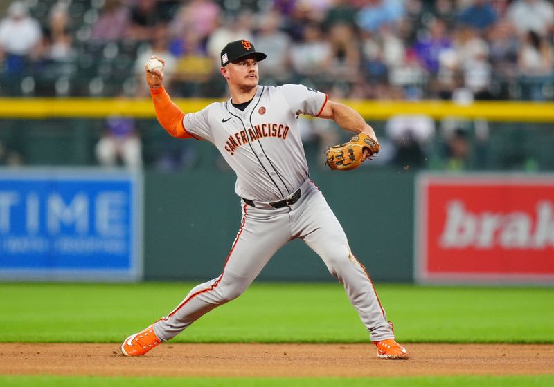 Jul 19, 2024; Denver, Colorado, USA; San Francisco Giants shortstop Brett Wisely (0) fields the ball during the first inning against the Colorado Rockies at Coors Field. Mandatory Credit: Ron Chenoy-USA TODAY Sports