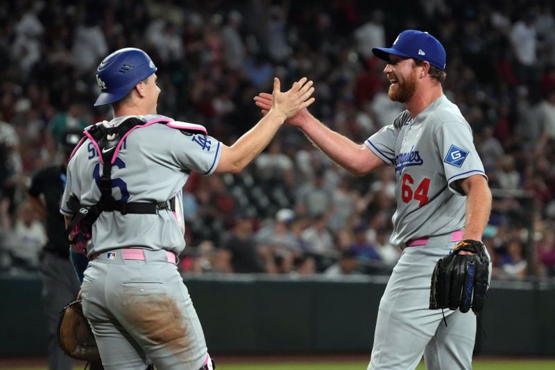 May 11, 2025; Phoenix, Arizona, USA; Los Angeles Dodgers catcher Will Smith (16) and pitcher Matt Sauer (64) celebrate after defeating the Arizona Diamondbacks at Chase Field. Mandatory Credit: Rick Scuteri-Imagn Images