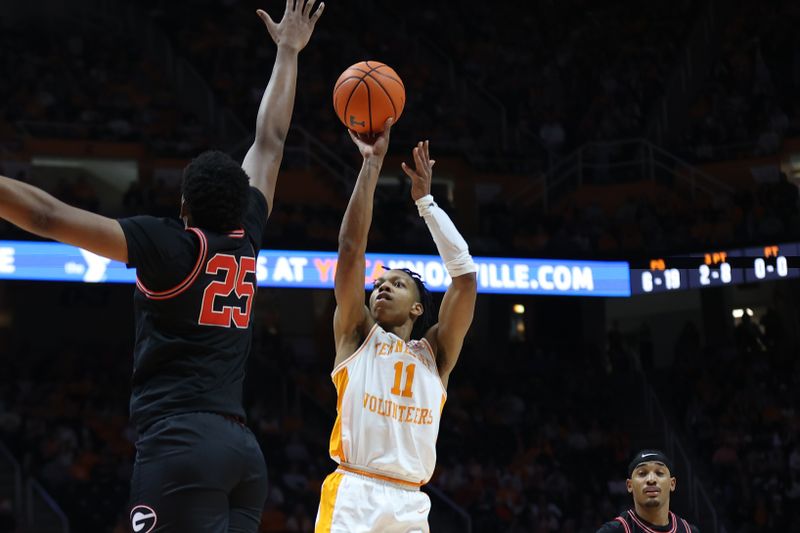 Jan 15, 2025; Knoxville, Tennessee, USA; Tennessee Volunteers guard Jordan Gainey (11) shoots against Georgia Bulldogs forward Justin Abson (25) during the first half at Thompson-Boling Arena at Food City Center. Mandatory Credit: Randy Sartin-Imagn Images