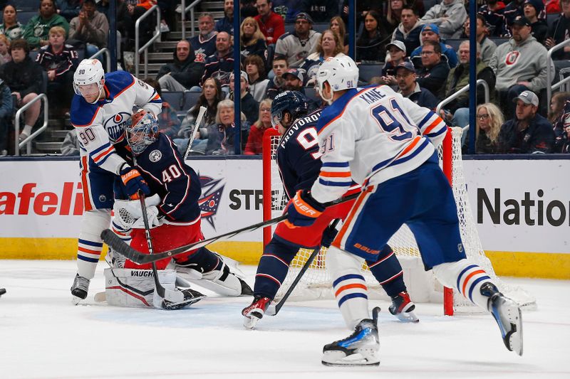 Mar 7, 2024; Columbus, Ohio, USA; Edmonton Oilers right wing Corey Perry (90) collides with Columbus Blue Jackets goalie Daniil Tarasov (40) as he makes a save during the second period at Nationwide Arena. Mandatory Credit: Russell LaBounty-USA TODAY Sports