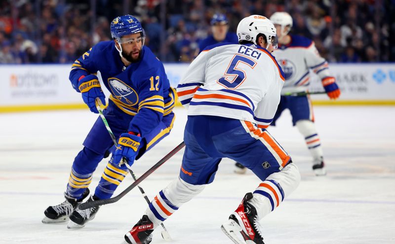 Mar 6, 2023; Buffalo, New York, USA;  Buffalo Sabres left wing Jordan Greenway (12) makes a pass during the second period against the Edmonton Oilers at KeyBank Center. Mandatory Credit: Timothy T. Ludwig-USA TODAY Sports