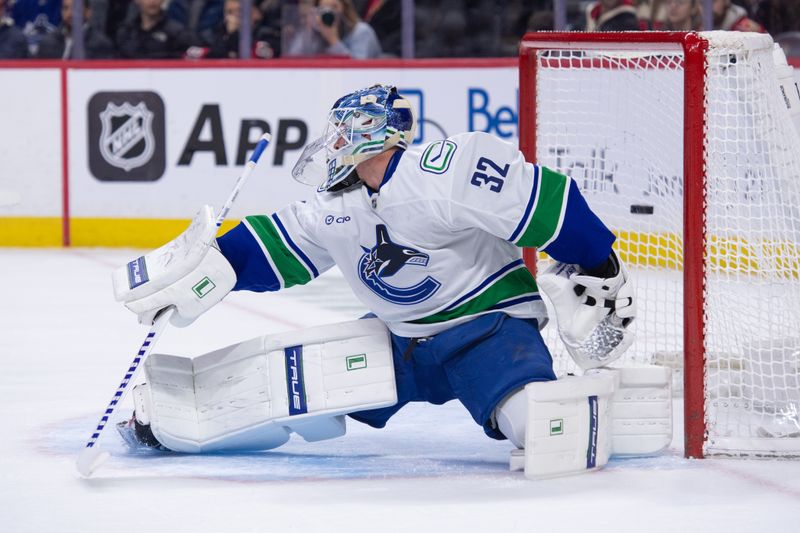 Jan 13, 2026; Ottawa, Ontario, CAN; Vancouver Canucks goalie Kevin Lankinen (32) is unable to stop a shot from Ottawa Senators center Jordan Spence (not pictured) in the first period at the Canadian Tire Centre. Mandatory Credit: Marc DesRosiers-IMAGN Images