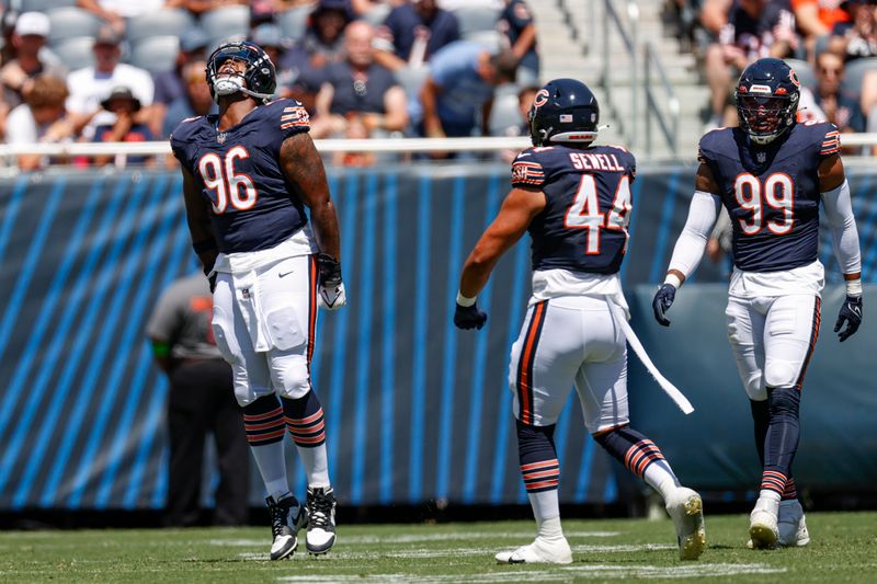 Chicago Bears defensive tackle Zacch Pickens (96) celebrates after sacking Tennessee Titans quarterback Will Levis during the first half of an NFL preseason football game against the Tennessee Titans, Saturday, Aug. 12, 2023, in Chicago. (AP Photo/Kamil Krzaczynski)