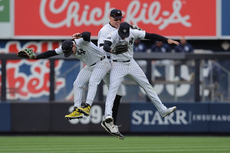 Apr 21, 2024; Bronx, New York, USA; New York Yankees left fielder Alex Verdugo (24) and center fielder Aaron Judge (99) and right fielder Juan Soto (22) celebrate after defeating the Tampa Bay Rays at Yankee Stadium. Mandatory Credit: Brad Penner-USA TODAY Sports