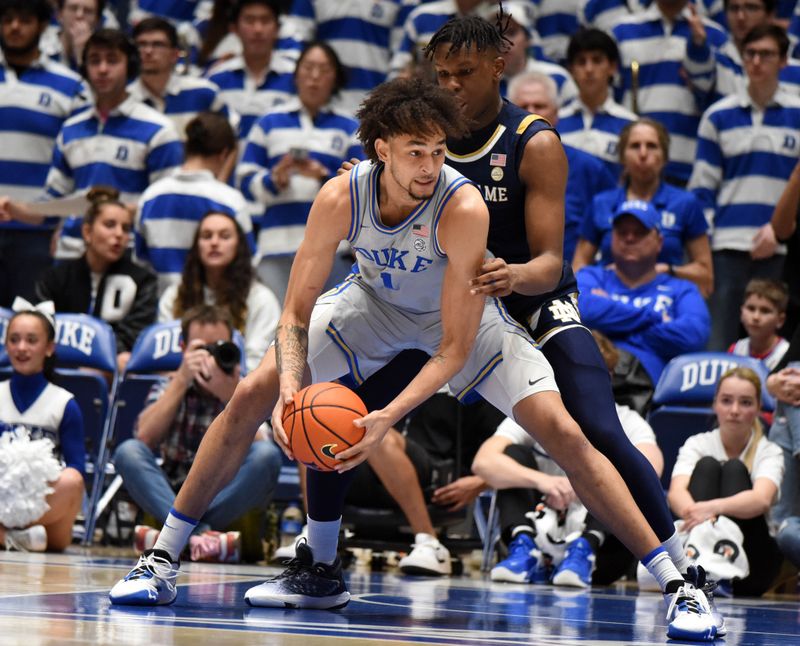 Feb 14, 2023; Durham, North Carolina, USA;  Duke Blue Devils center Dereck Lively (1) controls the ball in front of Notre Dame Fighting Irish forward Ven-Allen Lubin (2) during the first half at Cameron Indoor Stadium. Mandatory Credit: Rob Kinnan-USA TODAY Sports