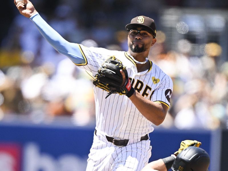 August 14, 2024; San Diego, California, USA; San Diego Padres second base Xander Bogaerts (2) forces Pittsburgh Pirates second base Jared Triolo (19) as he tries to turn a double play during the first inning at Petco Park. Bogaerts was unable to get the out at first base. Mandatory Credit: Denis Poroy-USA TODAY Sports at Petco Park. 